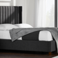 Side angle view of the Blackwell Bed in charcoal, highlighting it in a room setting - Mattress King