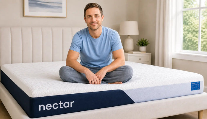 Customer sitting comfortably on a Nectar mattress from Mattress King