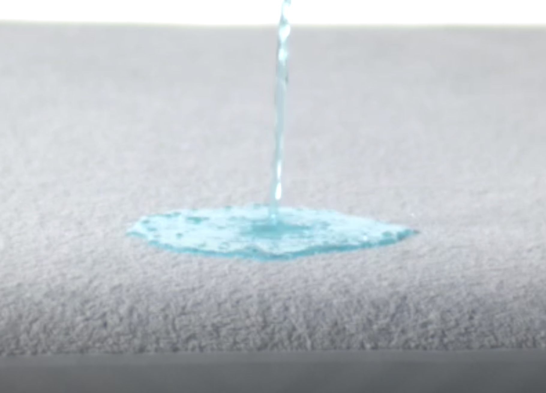 Video of a person spilling a liquid on the Mattress Protector to show it is waterproof - Mattress King